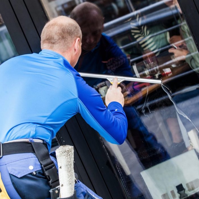 window washer working  wash glass on building